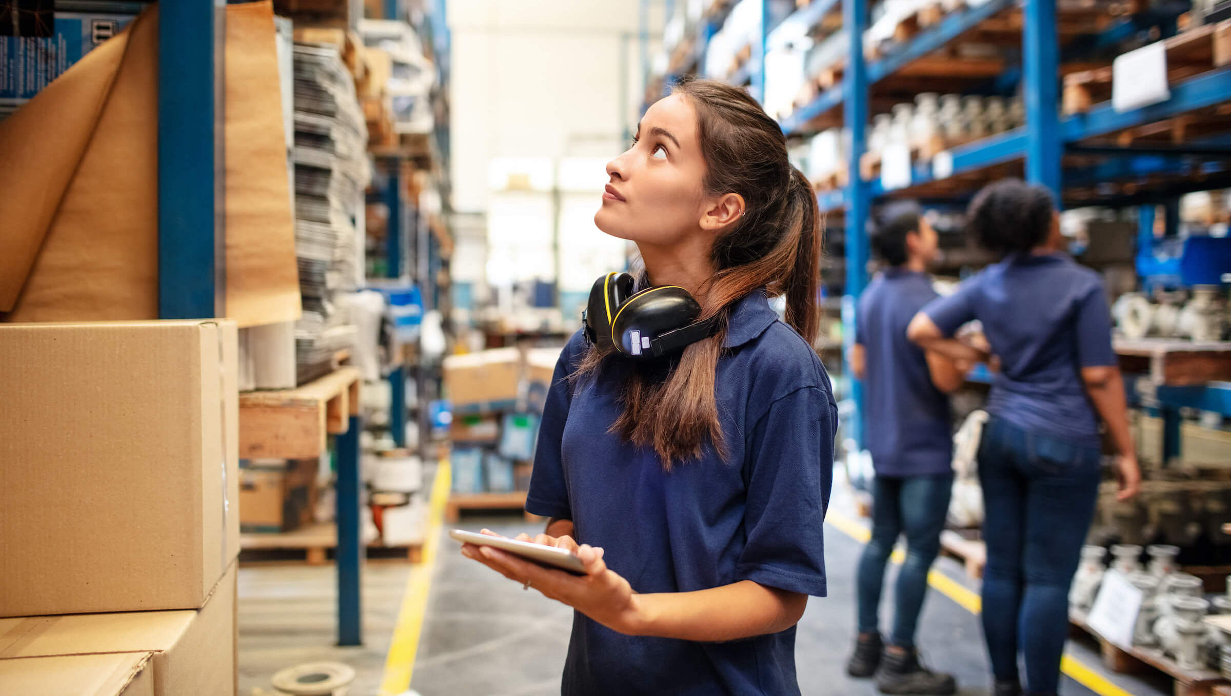 worker taking stock of business equipment in the warehouse