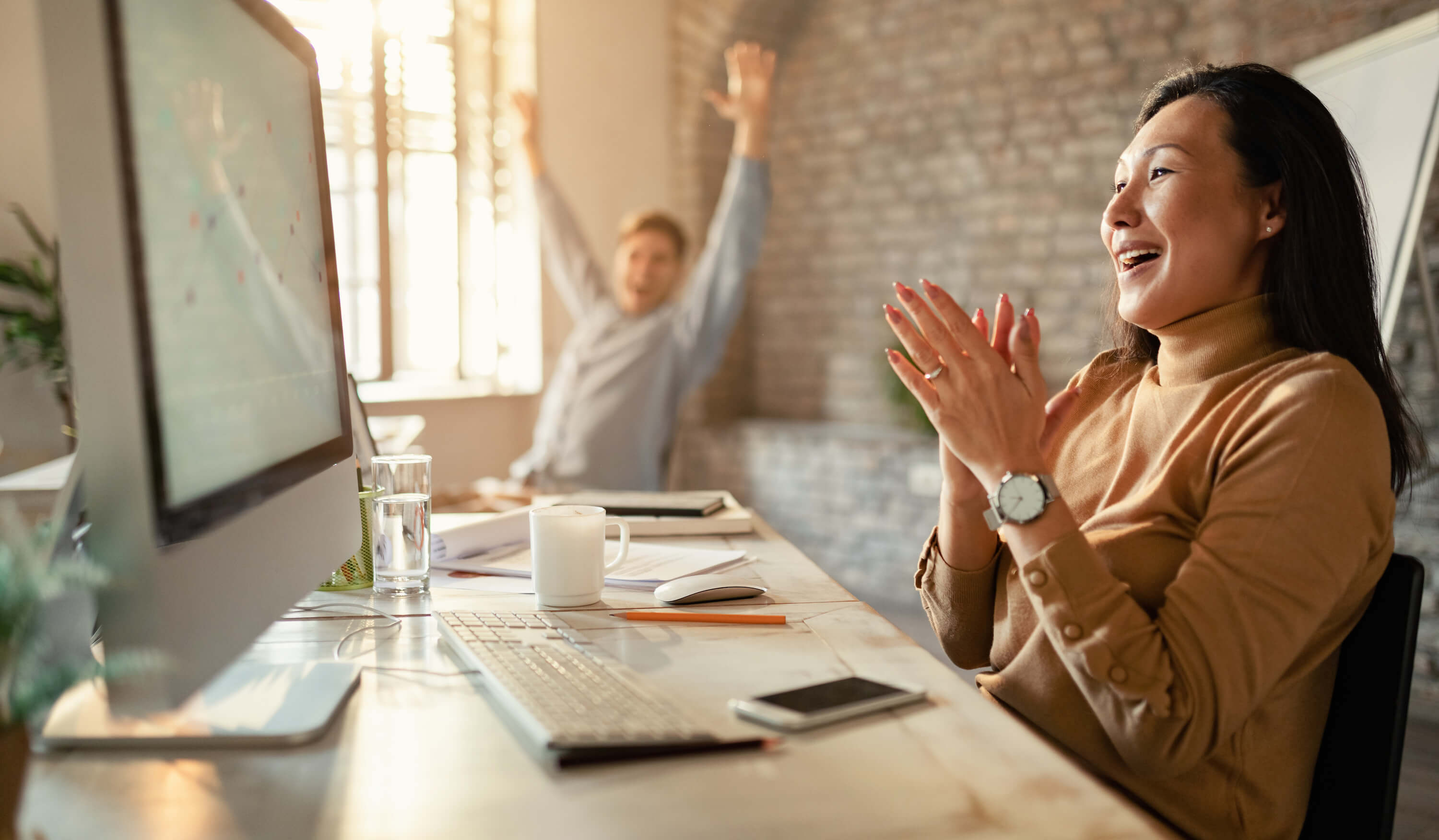 co workers celebrating business success for their startup